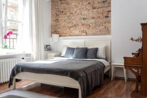 Posteľ alebo postele v izbe v ubytovaní Piano Apartment w sercu Starego Miasta
