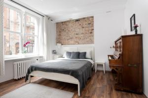 Posteľ alebo postele v izbe v ubytovaní Piano Apartment w sercu Starego Miasta