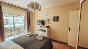 a bedroom with a bed with two towels on it at Very Central apartment with Terrace in Nice