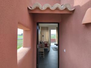 einen Flur eines Hauses mit einer rosa Wand in der Unterkunft La Cobija Apartamentos - Solo Adultos in Ciudad Real