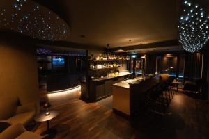 a bar in a restaurant with chairs and a counter at Hotel Atlantic Juist in Juist