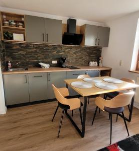 a kitchen with a table and chairs in a room at OTILIA apartment in Zell am See