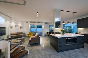 a kitchen and living room with a couch and a table at Villa Gardenya in Eilat