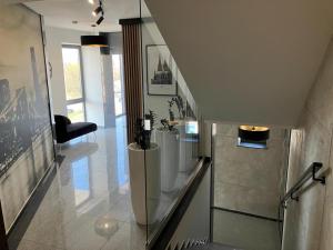 a hallway with a staircase with a chair in a building at ApartPort nowoczesne apartamenty in Gdynia +51 photos