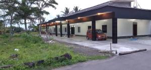 a van parked in front of a building at Lejo Grand Hotel in Cikembulan