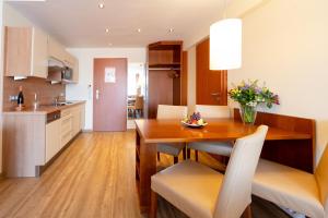 a kitchen and dining room with a table and chairs at Hotel Atlantic Juist in Juist