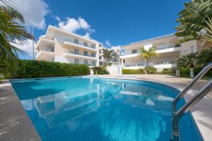 a swimming pool in front of a building at Porto de Mós 72 by Destination Algarve in Porto de Mós