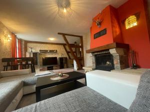 a living room with a couch and a fireplace at Landhotel Peters in Canow