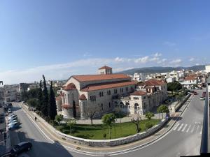 a large building on the side of a city street at Hotel Anastasia in Volos