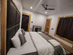 a large bed in a bedroom with a ceiling at Natures View Residency in Hundar
