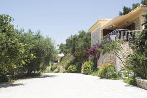 a road leading to a house with a balcony at Mary's Panorama Houses in Gialova