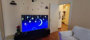 een woonkamer met een flatscreen-tv met sterren erop bij Azzurra holiday home - 850 m al mare - 75 mq - balconata vivibile - wi-fi - pay tv gratis - posteggio auto condominiale non assegnato in Rapallo +11 foto's