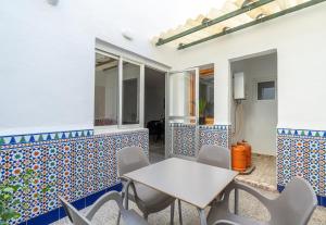 a table and chairs on a patio with blue and white tiles at Casa Granada budget Haus bei Granada in Dúrcal