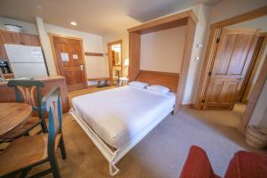 1 dormitorio con 1 cama, mesa y sillas en Red Hawk Lodge 2297, en Keystone