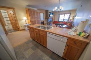 a kitchen with a sink and a living room at Red Hawk Lodge 2297 in Keystone