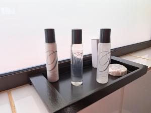 a shelf with three bottles on a window sill at Remhoogte Mountain Lodge in Jacksonstuin