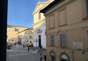 une rue urbaine avec des bâtiments et des gens qui marchent dans la rue dans l'établissement Julie - Graziosa casa del '700, à Castel Gandolfo
