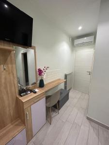 a room with a desk with a mirror and a television at Casa Quadrifoglio in Taranto