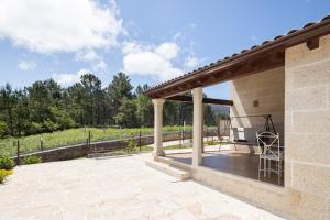 une terrasse avec pergola et banc dans l'établissement Pedra Moura Casa Rural, à Gondomar