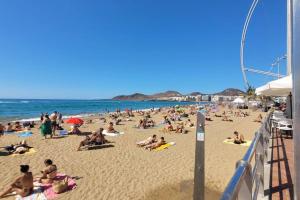 a large group of people on a beach at Lindamar Canteras Beach House in Las Palmas de Gran Canaria