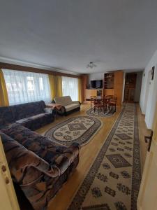 a living room with a couch and a table at Casa Kasandra in Buşteni