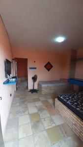 a room with two beds and a television in a room at Flat Casa Taiba 2001 in Taíba +2 photos