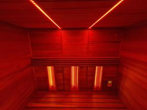 a staircase with red lights in a building at Villa a cappella in Binz