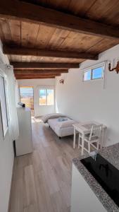a kitchen and living room with white walls and wooden ceilings at Salobre Blue Sky 3 in Salobre +4 photos