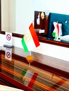 a hotel room with flags on top of a counter at HOTEL AYNI in Dushanbe