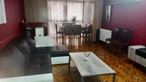 a living room with a couch and a table at Piso Ourense Bonito y Termal in Ourense