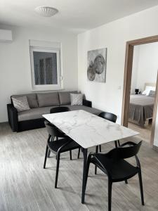 a living room with a table and chairs and a couch at Apartment Irene in Vir