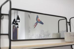 a mirror with a bird flying in the air at Emperador in Alghero