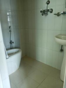 a bathroom with a tub and a sink and a toilet at Hotel Sarangkot in Pokhara