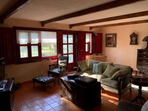 a living room with a couch and a table at Casa do Palheiro - Valença in Bade +26 photos