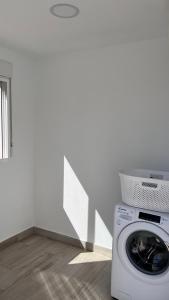 a washing machine in a room with a white wall at Salobre Blue Sky 2 in Salobre