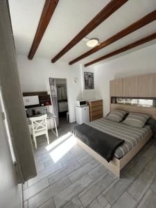 a bedroom with a large bed and a table at Beach House in Fos-sur-Mer