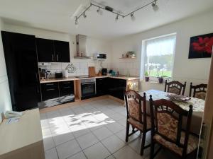 a kitchen with a table and a dining room at Ferienwohnungen Amselweg in Brandenburg West