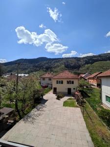 a view of a house with mountains in the background at Muzur Apartment in Sarajevo