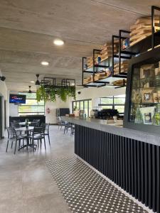 a restaurant with a bar with tables and chairs at 151 Ballito Luxury Villa in Ballito