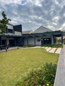 a building with a green lawn in front of it at 151 Ballito Luxury Villa in Ballito +19 photos