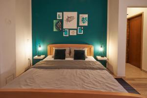 a bedroom with a large bed with green walls at Apartment Green in Poreč