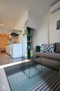 a living room with a couch and a table at Apartment Green in Poreč