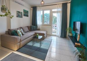 a living room with a couch and a tv at Apartment Green in Poreč
