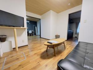 札幌市にあるリノベーション済み室内新築　Service Apartment Sapporoザ・ハウス4LDK86㎡のリビングルーム(テーブル、ソファ付)