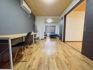 an office with a desk and chairs in a room at リノベーション済み室内新築　Service Apartment Sapporoザ・ハウス4LDK86㎡ in Sapporo