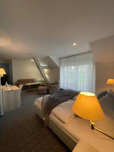 sypialnia z dużym łóżkiem i dużym oknem w obiekcie Eichenhof Hotel Garni w mieście Groß Köris