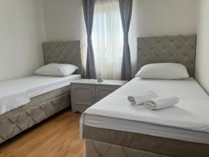 a bedroom with two beds with towels on them at Apartments Medic in Drače