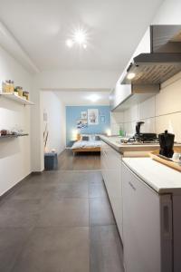 a large kitchen with white cabinets and a table at Apartment Blue in Poreč