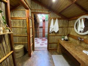 a bathroom with a large wooden room with a mirror at MOZBEVOK Coconut View Resort in Ponta do Ouro