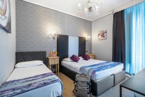 Łóżko lub łóżka w pokoju w obiekcie Hotel Relais Dei Papi